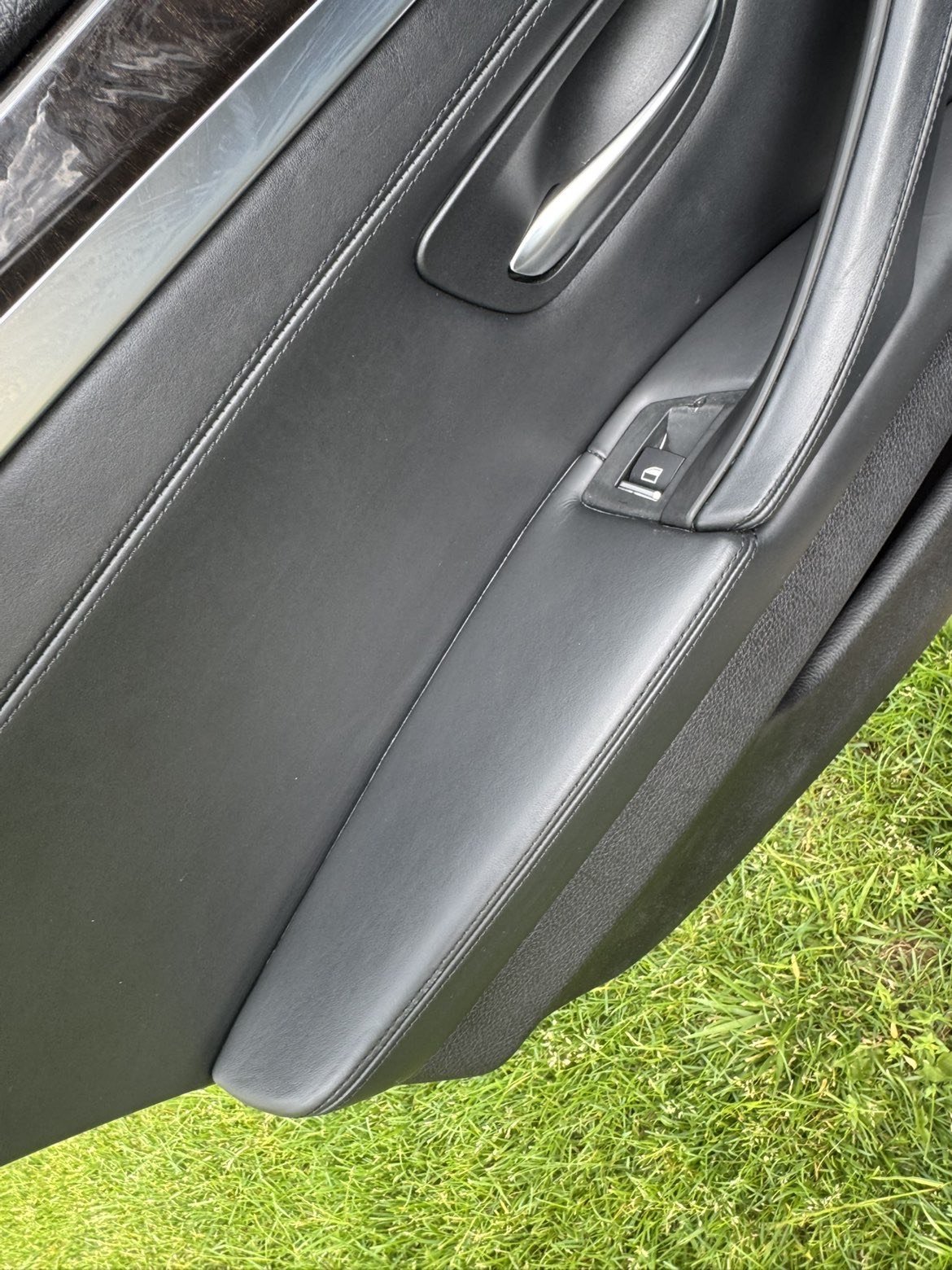 After: pristine car door panel with clean leather armrest and chrome trim, every speck of dust removed